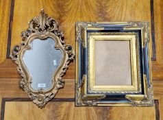 Gilt rococo wall mirror with cartouche-shaped plate, foliate surmount, 48cm high and a black and