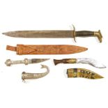 Two daggers, one Nepalese, brass-mounted applied with three coins and engraved bands to the