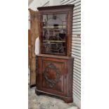Edwardian mahogany standing corner cupboard, the upper section having egg and dart moulded