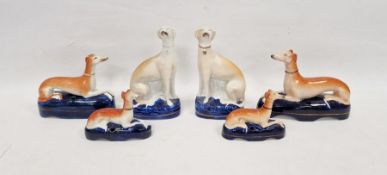 Group of late 19th century Staffordshire pottery models of greyhounds comprising a pair seated