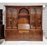 Edwardian mahogany library bookcase having moulded cornice, the central section rosette carved