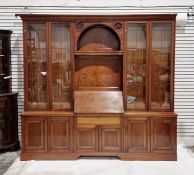 Edwardian mahogany library bookcase having moulded cornice, the central section rosette carved