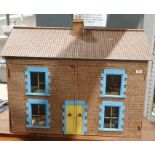 20th century painted board and paper covered doll's house with pair of panel doors to the front,