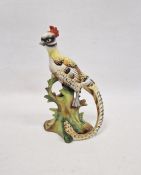 Early 20th century German porcelain model of a pheasant, naturalistically posed on a tree stump