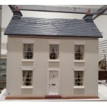 Cream painted wood doll's house in Georgian style and having lace curtains, together with a large