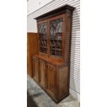 Victorian mahogany Gothic Revival-style library bookcase, having a moulded cornice over a pair of