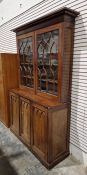 Victorian mahogany Gothic Revival-style library bookcase, having a moulded cornice over a pair of