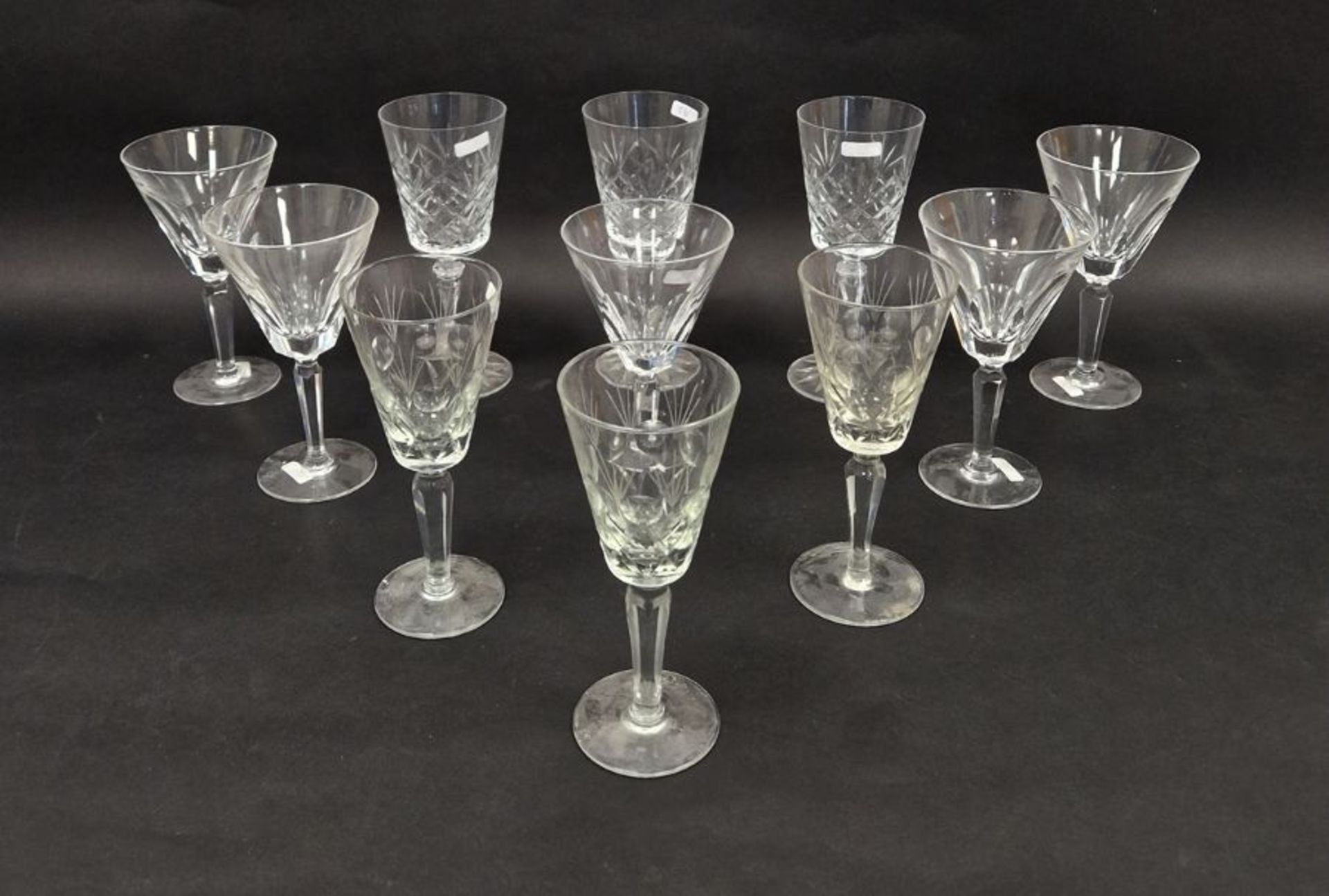 Five Waterford large cut glass wine glasses, etched marks, with lappet-cut conical bowls on