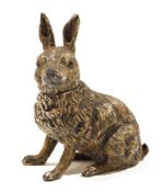 Cold-painted white metal hare inkwell having hinged head, 14cm high