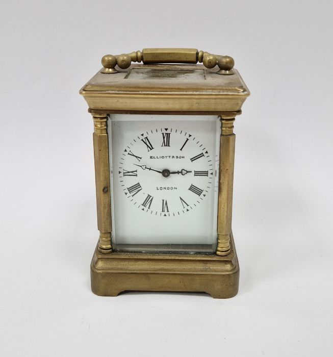 Brass miniature carriage clock in corniche case with faceted corner pilasters, the white enamel dial
