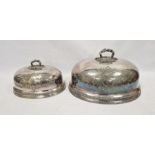 Two graduated 19th century silver-plated meat domes, each having scrolling engraved foliate motifs