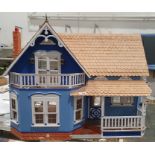 20th century painted wooden doll's house, with shingle roof and simulated brick chimney, with