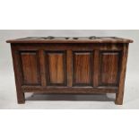 Reproduction stained pine blanket chest having a four panelled cover and front, iron hinges, on