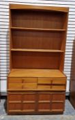 Mid century wall unit by Nathan, having two fixed shelves raised over four short drawers and a two