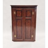 19th century oak hanging corner cupboard, the panelled doors with brass H-hinges, 112cm high x