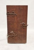 Antique iron-bound oak cabinet, the door with scroll hinges opening to sliding shelves and small