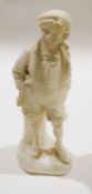 Carved marble figure of an urchin holding stick under his arm, 37cm high
