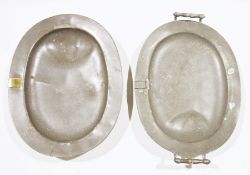 Two 19th century pewter two-handled warming trays, each of oval form with well, one with brass