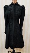 A 1940's black wool coat heavily embroidered with black detail and on the collar, hook and eye