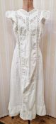 An Edwardian pinafore dress trimmed with embroidery anglaise, and tie fastening at the back, a