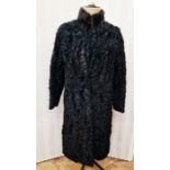 A black Astrakhan fur coat with a mink collar