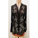 A vintage black chiffon jacket embroidered with small square glass beads and faux jet, elaborate