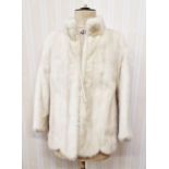 A cream mink jacket with scalloped hem, mandarin collar, (three quarter length bracelet sleeves,)