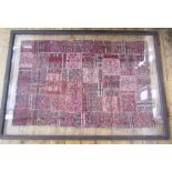 An antique handwoven panel, possibly Belouch, squares stitched together, 228 x 121 cms double glazed