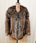 A vintage black grey fox fur jacket. No label. The inner seam lined with leather, there is a small