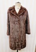 A vintage squirrel coat with embroidered satin lining, a short vintage fur cape labelled "Bobbys", a