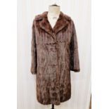 A vintage squirrel coat with embroidered satin lining, a short vintage fur cape labelled "Bobbys", a