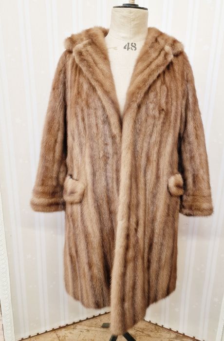 A 1960/70's brown mink coat, three quarter length half belt, button detail to the cuffs, side