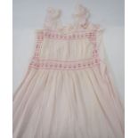 Two vintage night dresses with smocked detail to the neckline and bodice, one pink, one blue, a