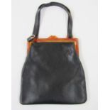 Mid 20th century leather handbag with amber-coloured bakelite fixed frame and leather handle, an