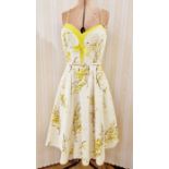 1960's cotton party dress with yellow forsythia printed onto a cream ground, yellow lining to the