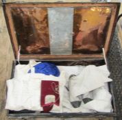 A vintage tin trunk containing assorted items to include padded garments for jiu jitsu/judo,