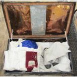 A vintage tin trunk containing assorted items to include padded garments for jiu jitsu/judo,