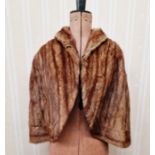 A vintage musquash fur cape, a grey possibly marten fur coat labelled "Harrisons of Gloucester" (2)