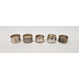 Five assorted silver napkin rings, two having engine turned decoration, gross weight approximately