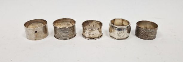 Five assorted silver napkin rings, two having engine turned decoration, gross weight approximately