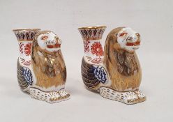 Pair of Royal Crown Derby bone china imari pattern mythical beast candlesticks, each modelled as a
