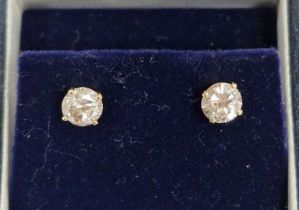 Pair gold-coloured metal (possibly 18ct gold) and diamond solitaire earrings, claw set, each stone
