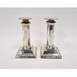 Pair Edwardian silver candlesticks, each octagonal and panelled on square bevelled foot, 15cm high,
