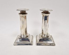 Pair Edwardian silver candlesticks, each octagonal and panelled on square bevelled foot, 15cm high,