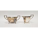 George VI silver twin handled sugar bowl and matching milk jug, of octagonal form raised on paw