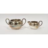 George V silver twin handled sugar dish and a matching silver cream jug, hallmarked Chester 1913