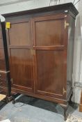 Early 20th century mahogany two-door wardrobe mounted with ornate brass hinges and escutcheons,