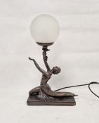 Contemporary Art Deco-style bronzed resin table lamp, with frosted globe shade supported by a