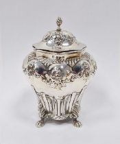 Victorian silver tea caddy with domed top, shouldered and tapering with floral repousse, four paw