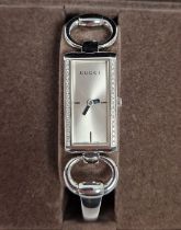 Gucci Tornabuoni 119 lady's wristwatch, the rectangular dial surrounded with small diamonds on the